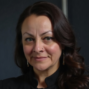 Headshot of a woman smiling at the camera, wearing black.