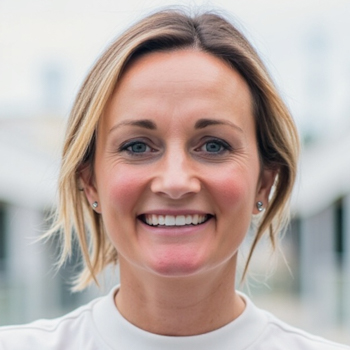 Headshot of a woman smiling at the camera in a white shirt.