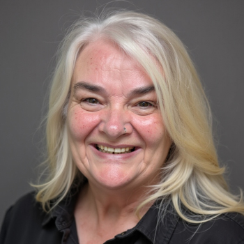 Headshot of a woman smiling with whitening blonde hair.