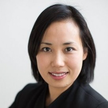 Headshot of a woman with black hair smiling at the camera.